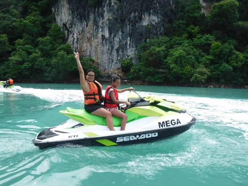 Two women maneuvering a jetski at Langkawi jetski tour by Mega Water Sports